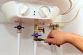 Domestic plumbing connections. Connection of home water heater. Fixing electric water heater boiler Royalty Free Stock Photo