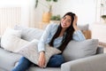 Domestic Portrait. Cheerful Korean Woman Posing On Comfy Couch At Home