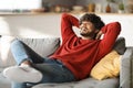 Domestic Rest. Relaxed Young Indian Man Leaning Back On Couch At Home