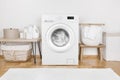 Domestic room interior with modern washing machine and laundry baskets Royalty Free Stock Photo