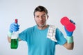 Domestic service man or tired husband angry and stressed house cleaning with spray bottle and sponge