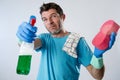 Domestic service man or tired husband angry and stressed house cleaning with spray bottle and sponge