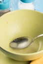 Domestic soup bowl with metal spoon on the table Royalty Free Stock Photo