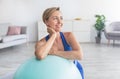 Smiling Sporty Woman Exercising Leaning On Ball At Home Royalty Free Stock Photo