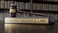 Domestic violence law: Judge's Gavel as a symbol of legal system and wooden stand with text word on the background Royalty Free Stock Photo