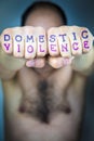 DOMESTIC VIOLENCE written on the fists of a man