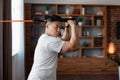 Domestic workout concept. Sporty asian mature man exercising with resistance rubber band, training in living room Royalty Free Stock Photo