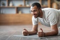 Domestic Workout. Sporty African American Guy Doing Elbow Plank Exercise At Home Royalty Free Stock Photo