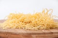 Domestic yellow noodles on a kitchen board