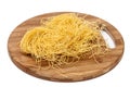 Domestic yellow noodles on a kitchen board