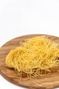 Domestic yellow noodles on a kitchen board