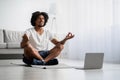 Domestic Yoga. Handsome Black Guy Meditating In Front Of Laptop At Home