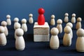 Dominance, power and leadership. Red wooden figurine on blocks