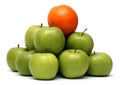 Domination concepts - orange on pyramyd of apples Royalty Free Stock Photo