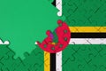 Dominica flag is depicted on a completed jigsaw puzzle with free green copy space on the left side