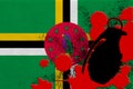Dominica flag and MK2 frag grenade in red blood. Concept for terror attack or military operations with lethal outcome