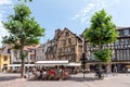 Dominican square in Colmar, France with half timbered houses and tourists, enjoying sitting in the cafes at a summer day