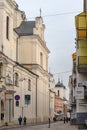 Dominican Street with churches, dwellings and passers-by at noon Saturday in Vilnius Royalty Free Stock Photo