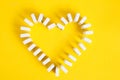 Domino chips in shape heart yellow background.Love for domino board game Royalty Free Stock Photo