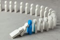 Domino effect in business. One businessman falls and brings down other figures of employees. Prevent the destruction of the system