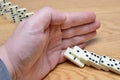 Domino effect, chain reaction is stopped by a human hand Royalty Free Stock Photo