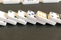 Domino effect shot. Look down for domino game on black background. Dominoes falling in a row in front. Dominoes Game Pieces Royalty Free Stock Photo