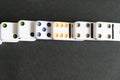 Domino effect shot. Look down for domino game on black background. Dominoes falling in a row in front. Dominoes Game Royalty Free Stock Photo