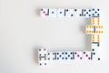 Domino effect shot. Look down for domino game. Dominoes falling in a row in front. Dominoes Game Pieces on White Royalty Free Stock Photo