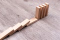 Domino effect. Wooden toy blocks on the ground Royalty Free Stock Photo