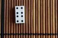 Domino piece on the bamboo brown wooden table background. Domino set - four - 4 dots.