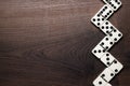 Domino pieces forming zigzag over wooden table