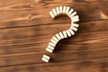 Domino question mark on wooden table. Domino principle Royalty Free Stock Photo