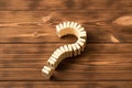 Domino question mark on wooden table. Domino principle Royalty Free Stock Photo