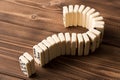 Domino question mark on wooden table. Domino principle Royalty Free Stock Photo