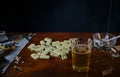 Dominoes, beer in a glass, a smoking cigarette in an ashtray and salted fish for beer. Royalty Free Stock Photo