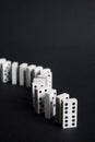 Dominoes line and leader business concept black background Royalty Free Stock Photo