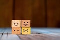 Dominoes on wooden background. Emoticon face on Wooden Cube.