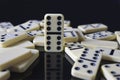 Dominos fallen around a double six Royalty Free Stock Photo