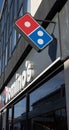 Dominos Pizza Take Out Restaurant logo and company name signs on exterior of building