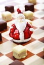 Dominostein Christmas pastry with chocolate icing on chess boar