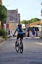 Tourists on bike in the street of Domme in Dordogne