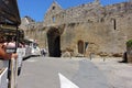 Tourists riding on the little tourist train about to pass through the Tower gate in the town of Domme Royalty Free Stock Photo