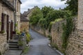 Domme, France - picturesque street with stone houses and blossoming flowers in the historic village of Domme in the Dordogne