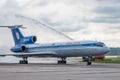 Domodedovo airport, Moscow - July 11th, 2015: Tupolev Tu-154M EW-85748 of Belavia Airlines greeted by water arch