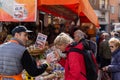 Domodossola, Italy - March 09 2019: Man and woman discussing on crowded marketplace.