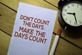 Don`t Count The Days. Make The Days Count text on the paper isolated on table background Royalty Free Stock Photo