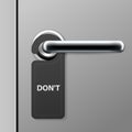 Don`t disturb sign - hotel door hanger on doorknob - door handle in motel Royalty Free Stock Photo