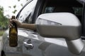 Female Driving Car Holding Alcoholic Bottle