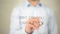 Don't Find Fault, Find a Remedy, Man writing on transparent screen Royalty Free Stock Photo