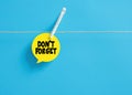 Don't forget message reminder on a speech bubble hanging on clothesline with a clothespin Royalty Free Stock Photo